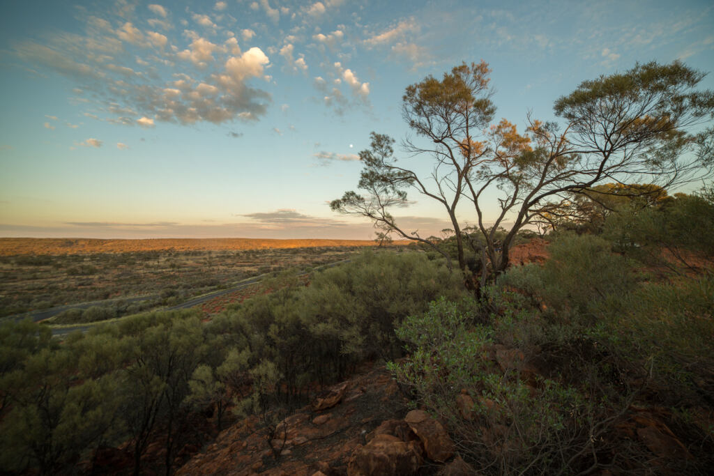 Beautiful sun setting down on the Australian outback. Kings Canyon in the far horizon