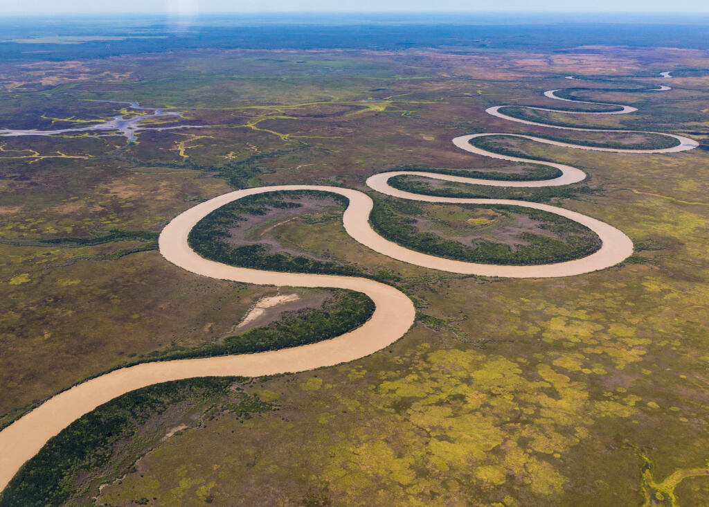 Aerial view taken of the Adelaide River, from a small fixed wing aircraft heading east to west inland at the end of the wet season in the Top End, Northern Territory Australia.