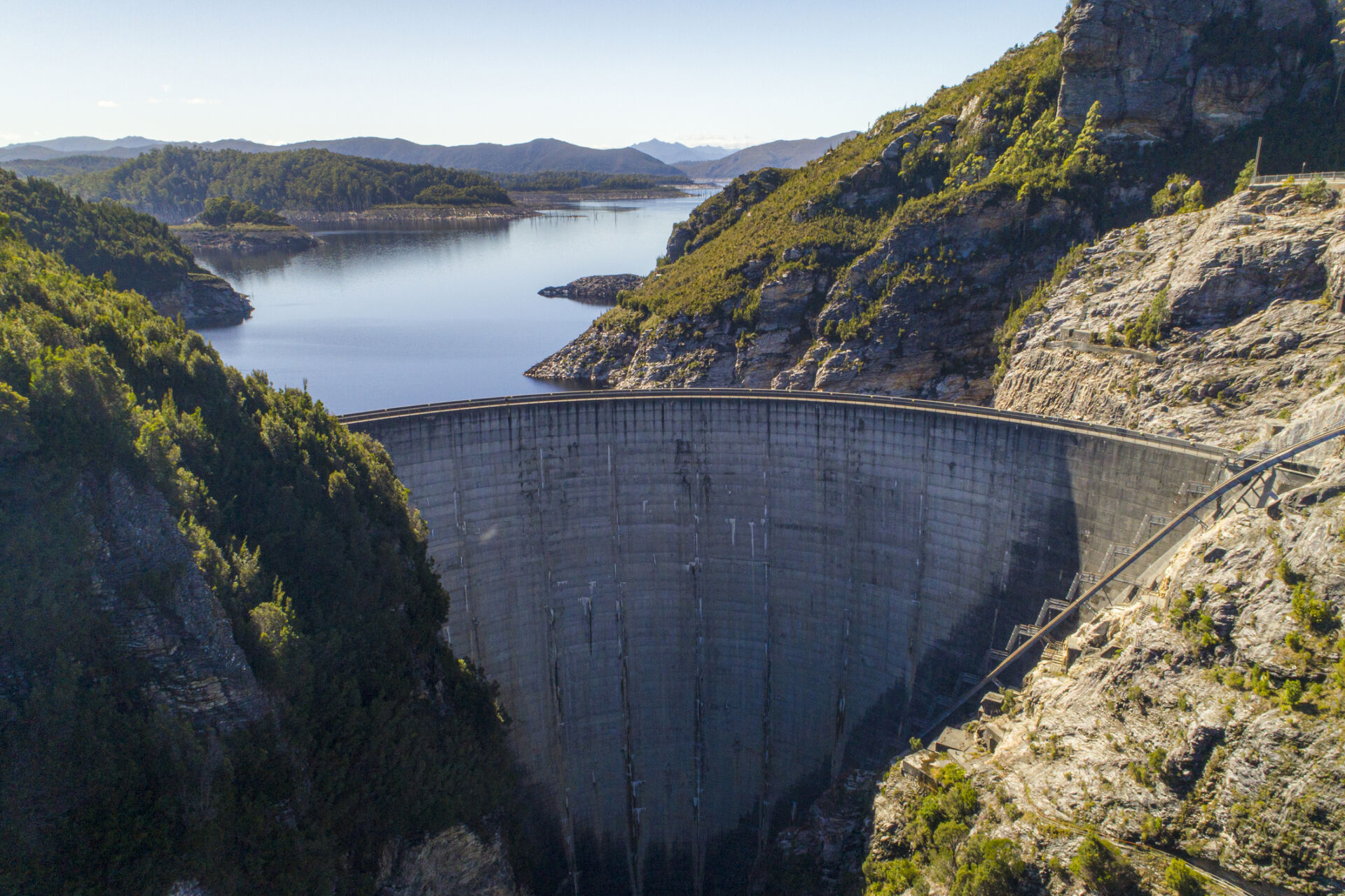 Aerial view of enormous cement dam on a sunny day in Tasmania, Australia