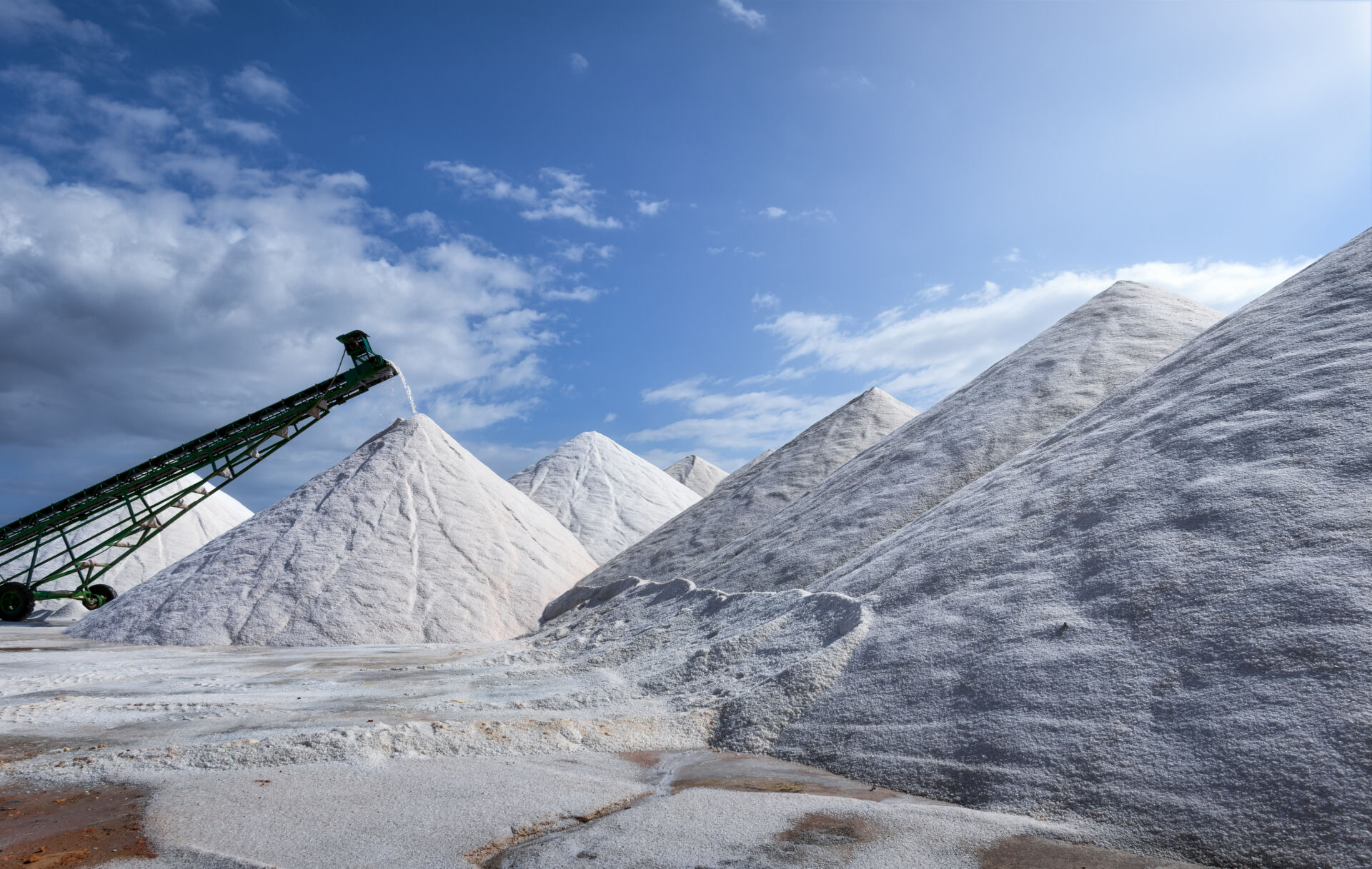 A salt evaporation pond is a shallow artificial salt pan designed to extract salts from sea water or other brines. Natural salt pans are geological formations that are also created by water evaporating and leaving behind salts. Salt evaporation ponds may also be called salterns, salt works or salt pans.