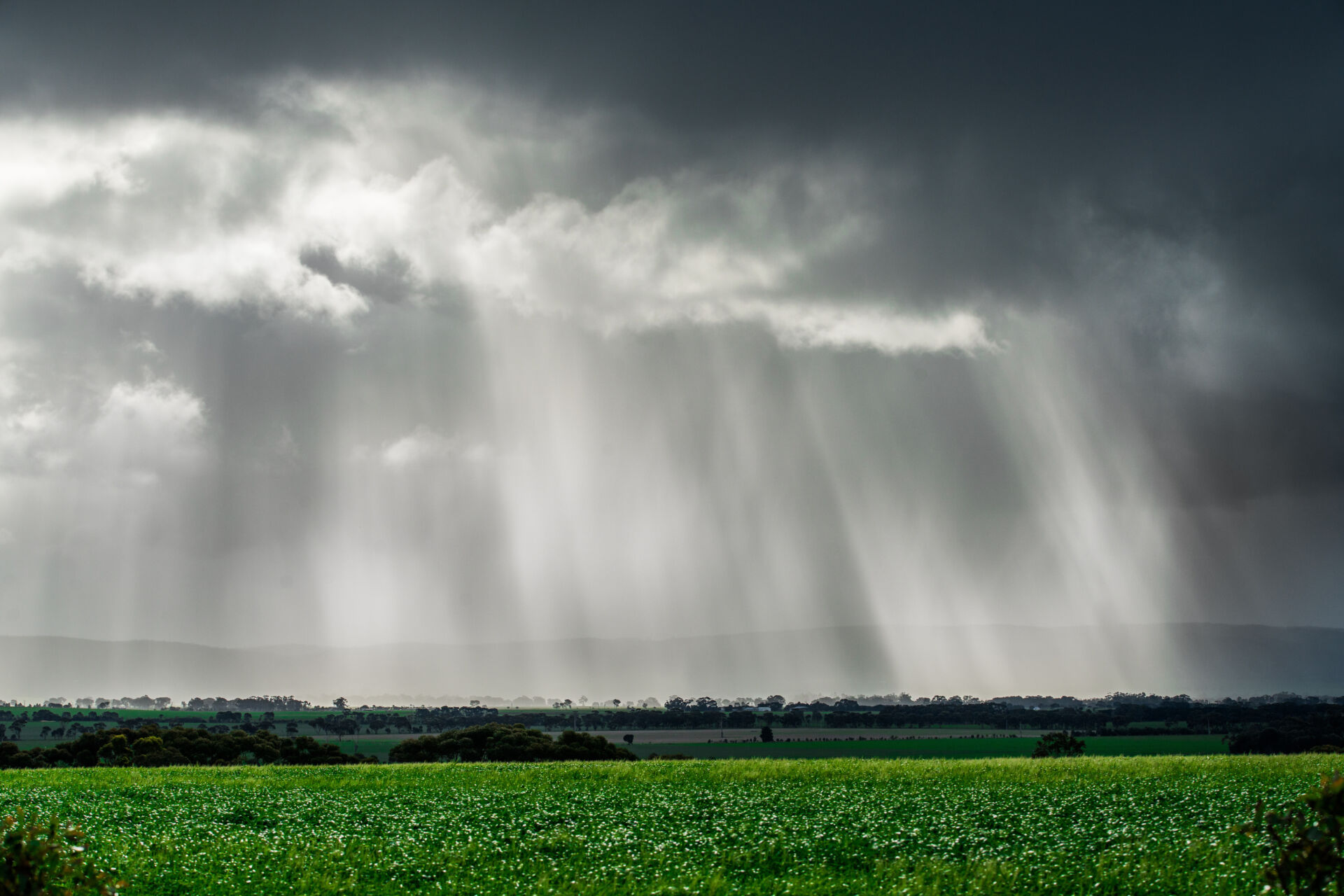 Rain and sun between clouds near the You Yangs Mountains in Victoria, Australia.