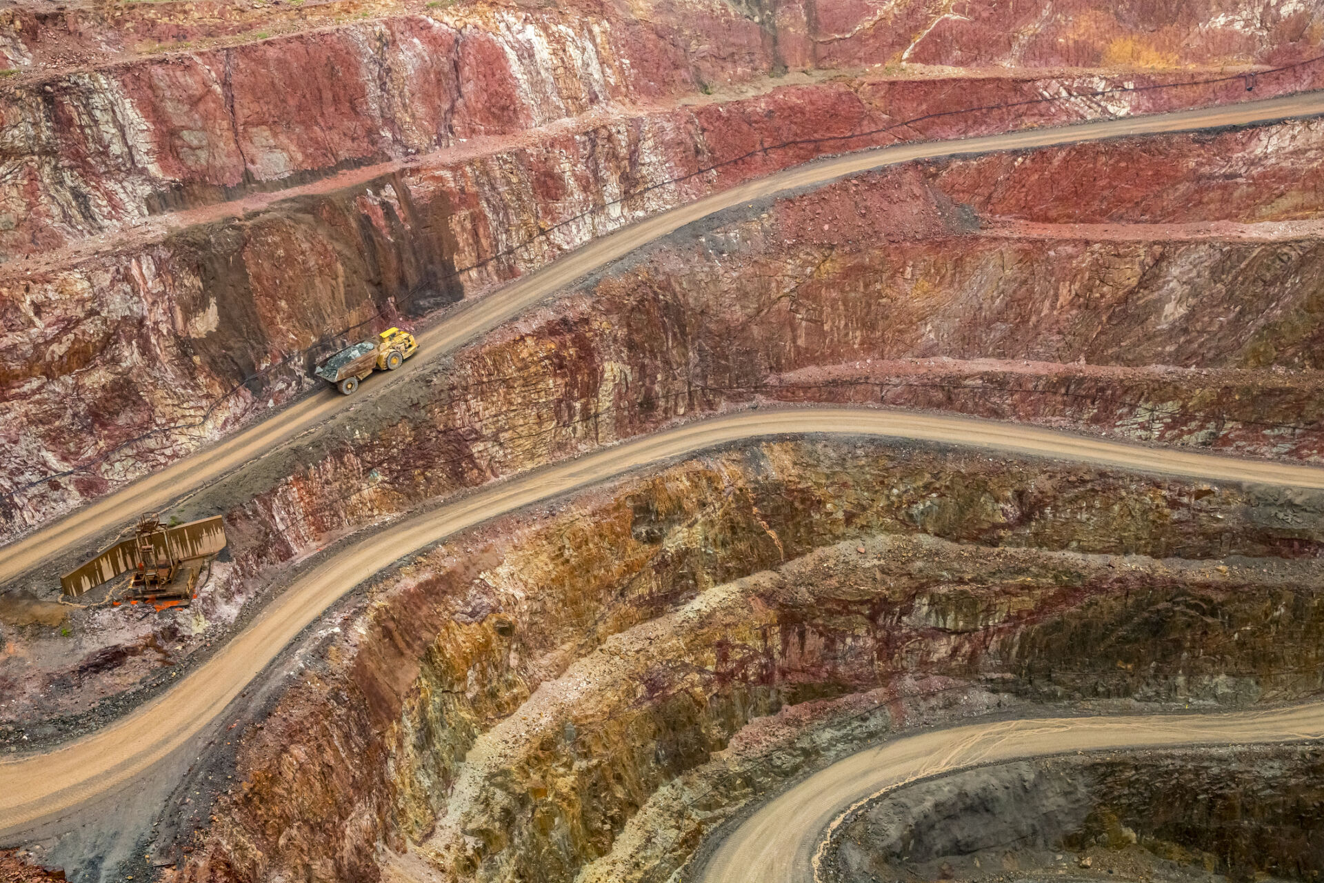 Open cut Gold mine, with Haul truck driving up road. Located in Cobar NSW Australia.